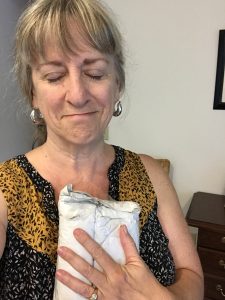 Cidney hugs her packaged cell phone with joy.