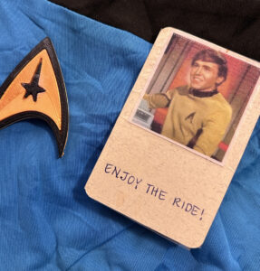 A credit-card size card with Ensign Pavel Chekhov on it beside a Starfleet symbol on a blue background.